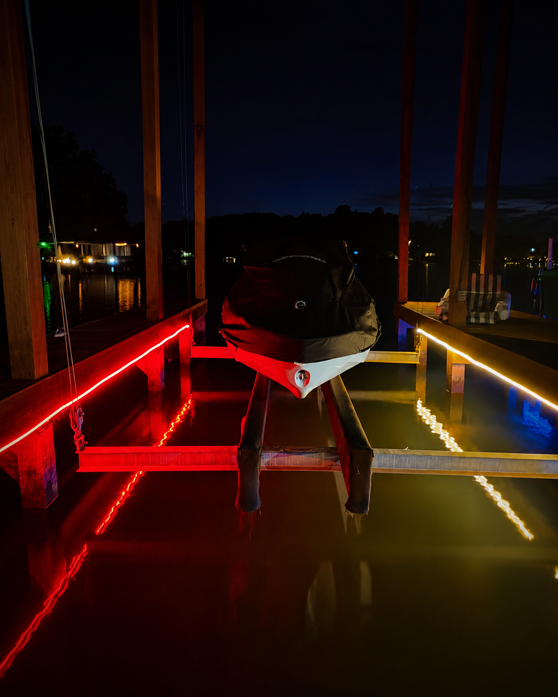 Boat dock with red and white neon accent railing lighting