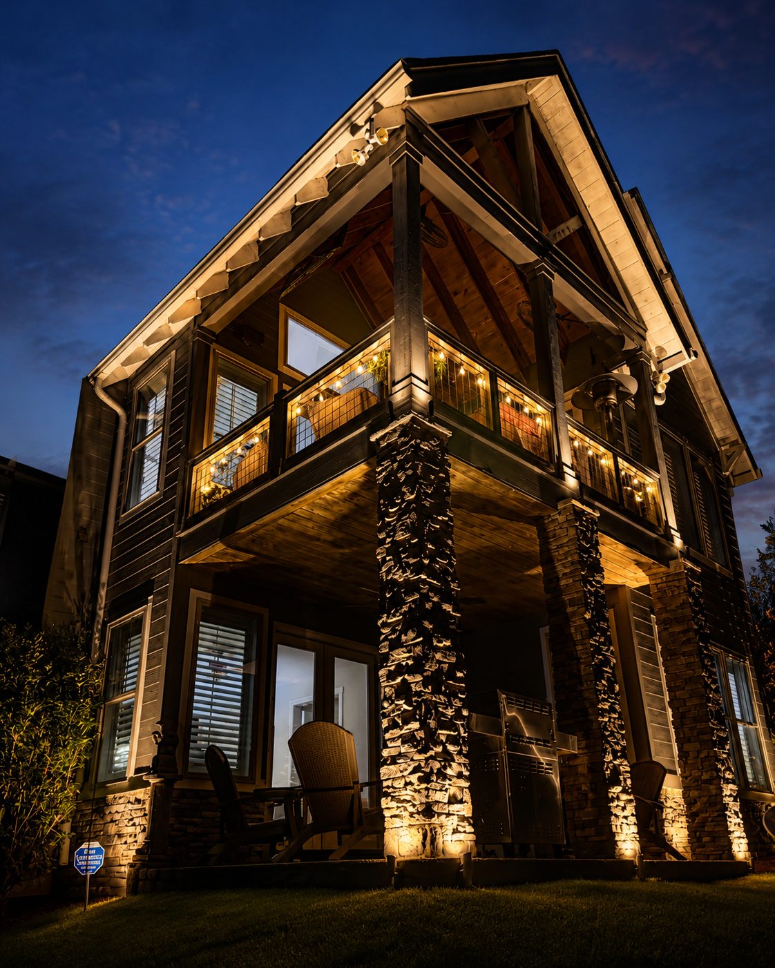 Two-story colonial home with comprehensive facade lighting